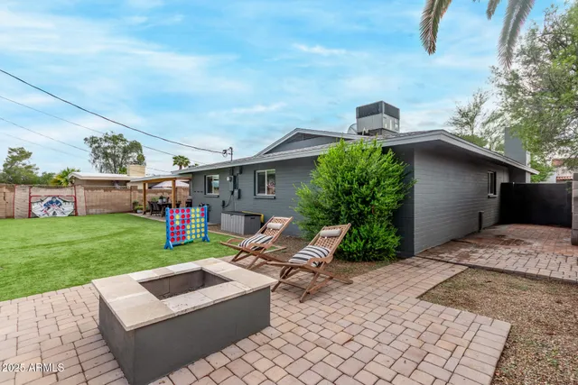 a view of backyard with outdoor seating ad green space