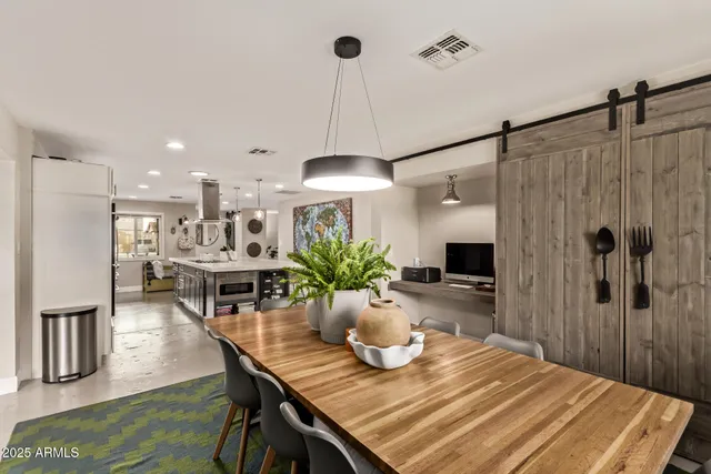 a dining room with furniture and a chandelier