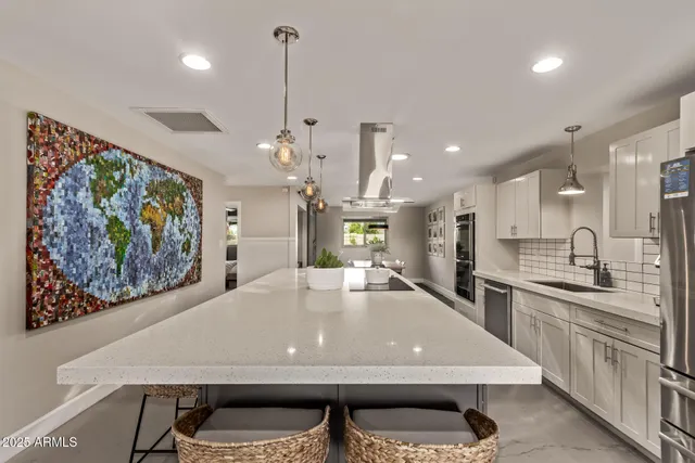 a large kitchen with a table and chairs