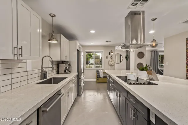 a kitchen with stainless steel appliances a sink stove and cabinets