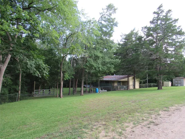 a view of a house with a yard and sitting area