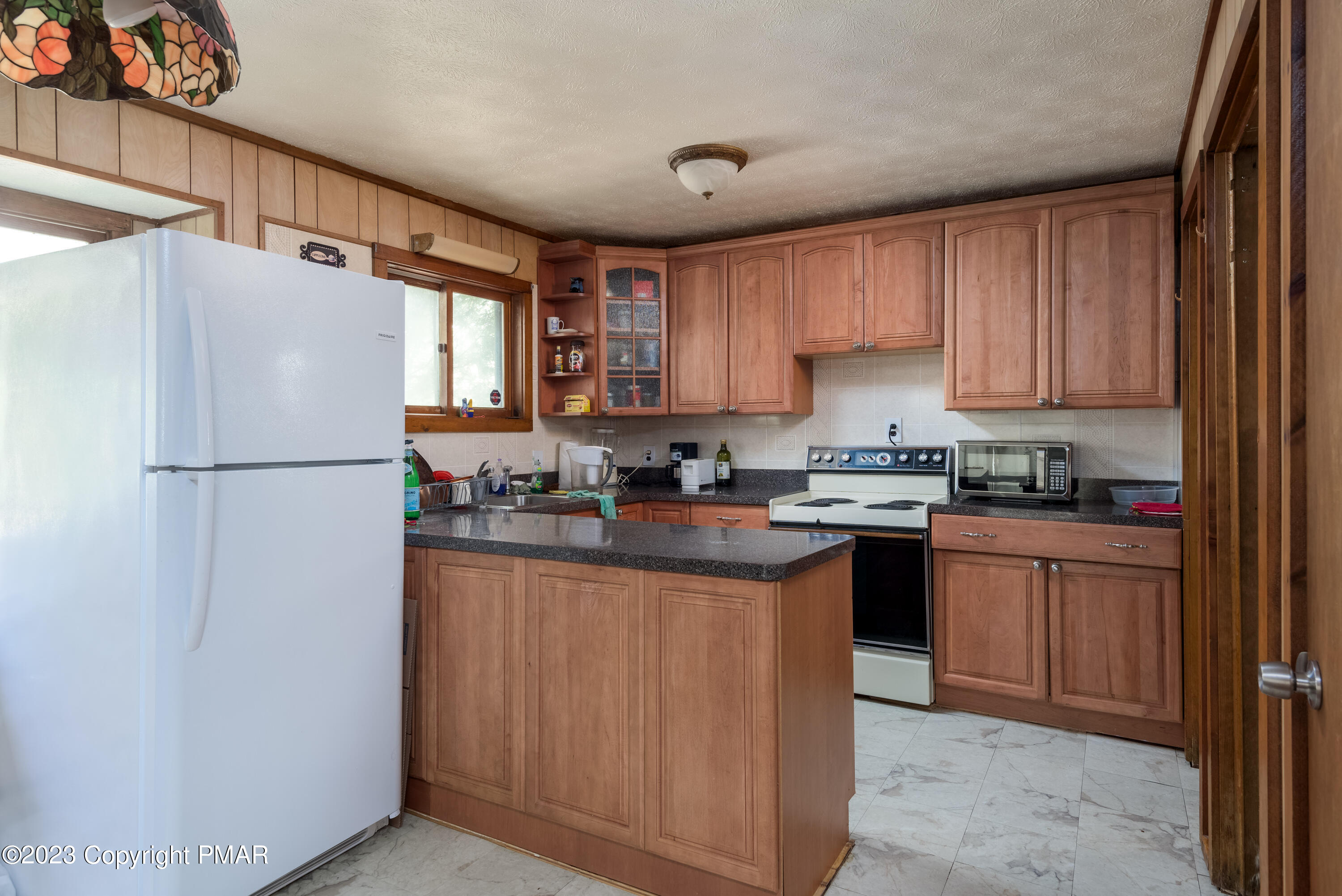 2206 Chatham Drive Bushkill, PA 18324 - Photo 18 of 25 a kitchen with granite countertop stainless steel appliances a refrigerator a sink and a cabinets