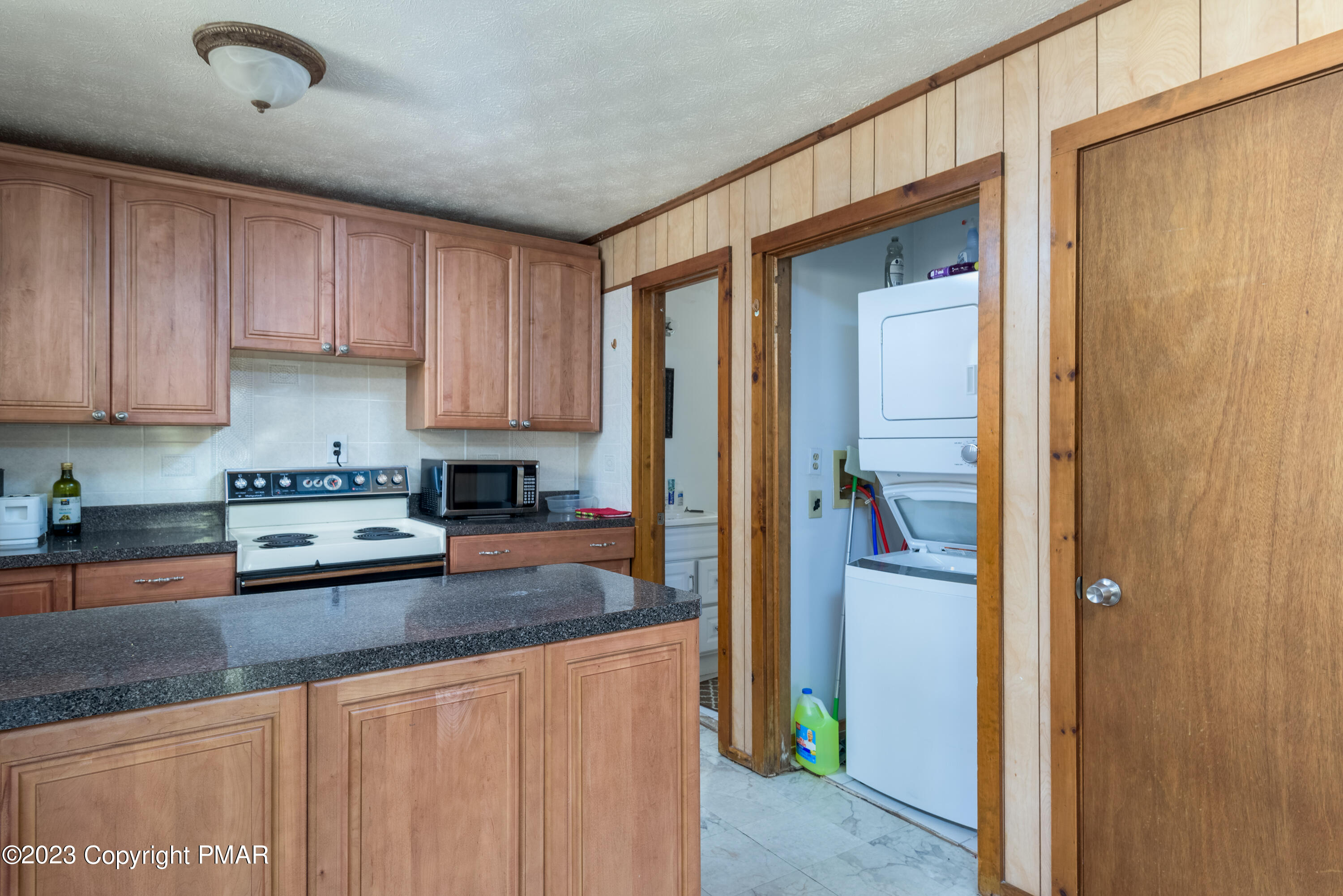 2206 Chatham Drive Bushkill, PA 18324 - Photo 19 of 25 a kitchen with stainless steel appliances granite countertop a refrigerator a stove and a sink with wooden floor
