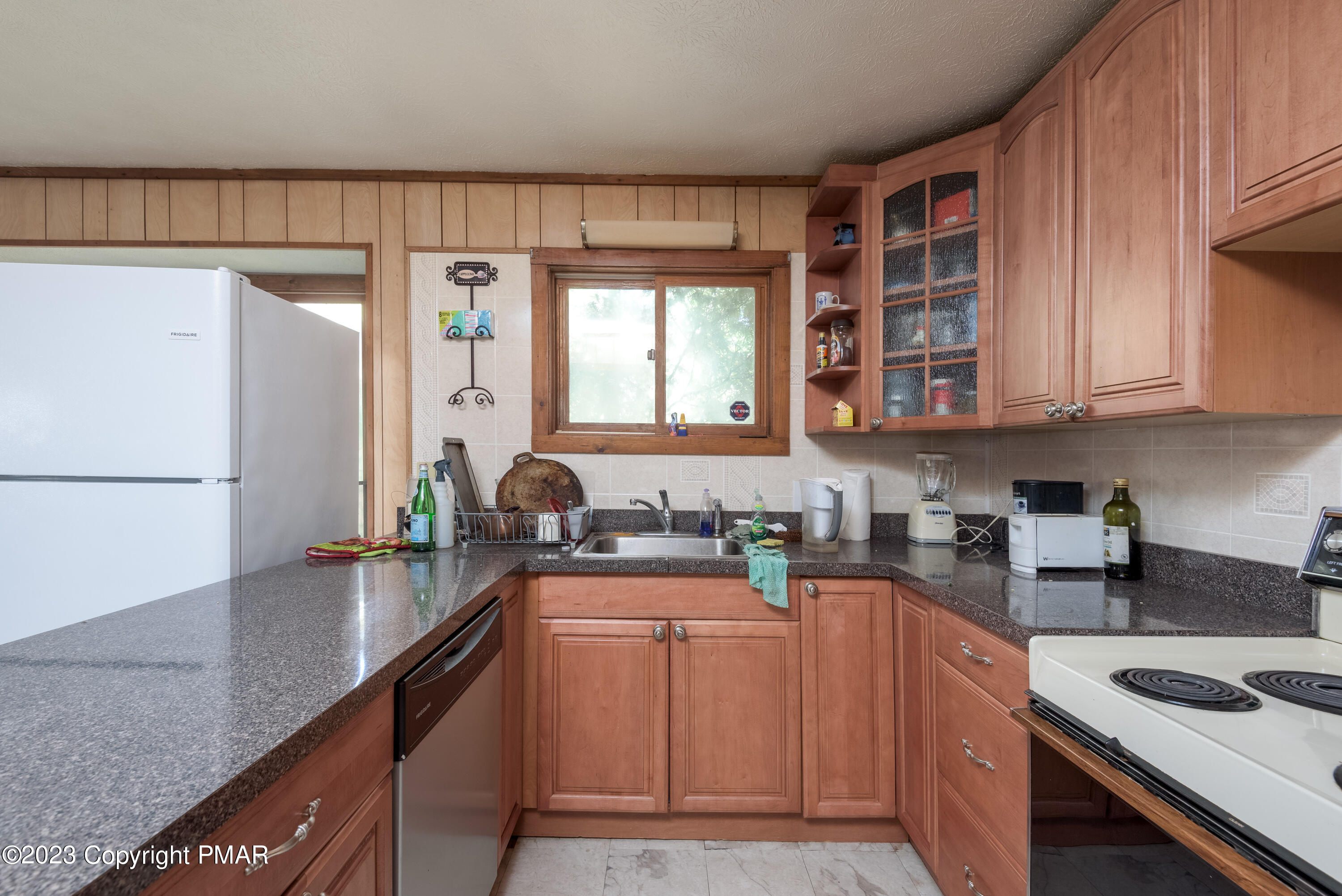2206 Chatham Drive Bushkill, PA 18324 - Photo 3 of 25 a kitchen with granite countertop a sink stove and cabinets