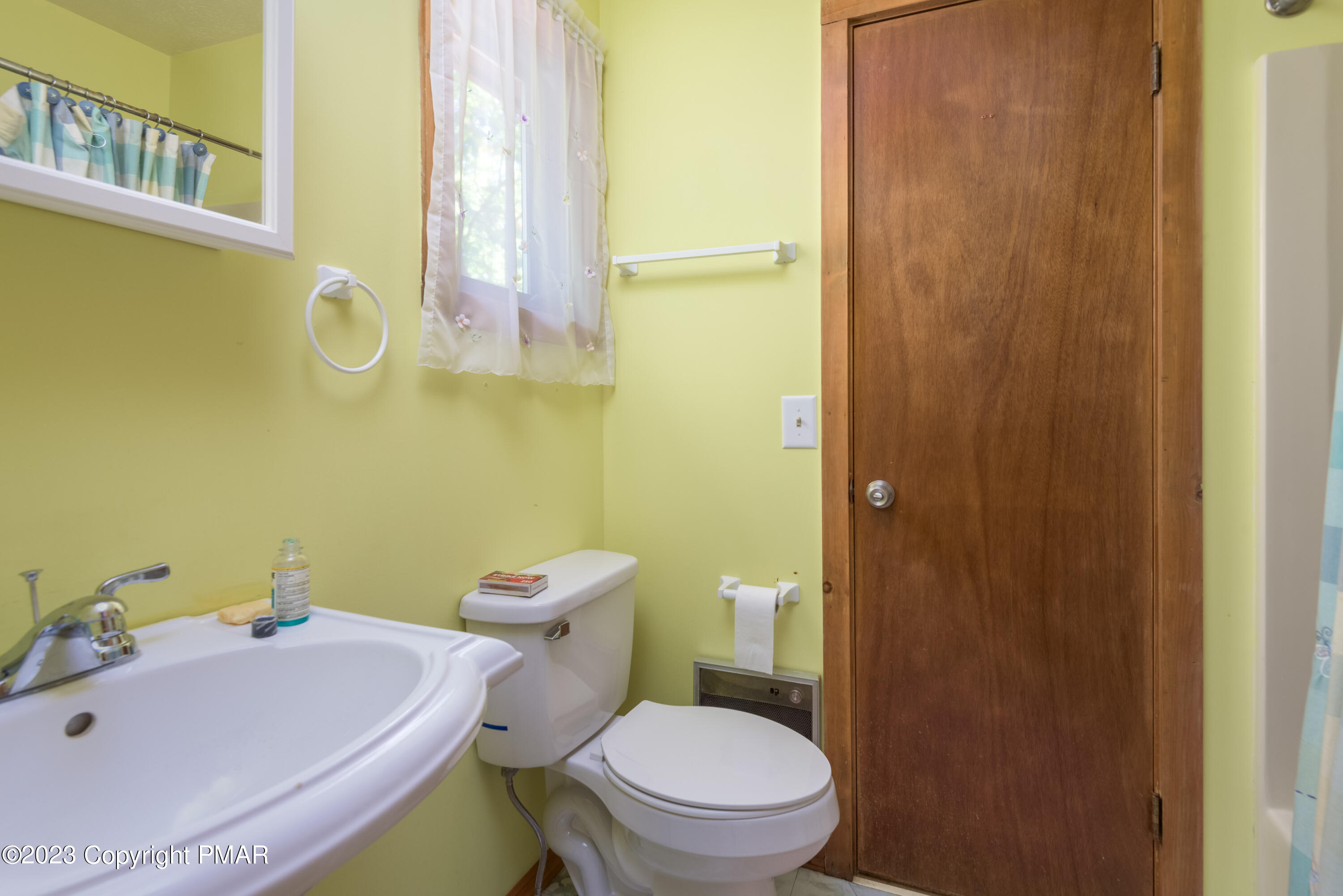 2206 Chatham Drive Bushkill, PA 18324 - Photo 9 of 25 a white toilet sitting next to a bathroom sink and vanity