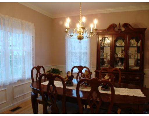 17 Boundary Stone Road Sutton, MA 01590 - Photo 13 of 24 a view of a dining room with furniture and chandelier