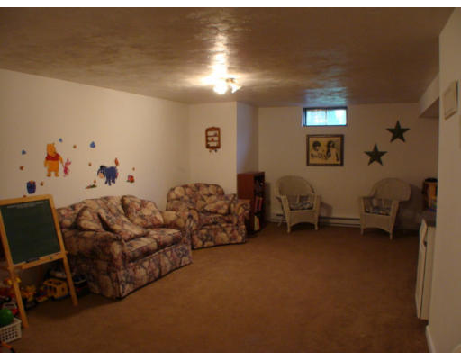 17 Boundary Stone Road Sutton, MA 01590 - Photo 22 of 24 a living room with furniture and a chair