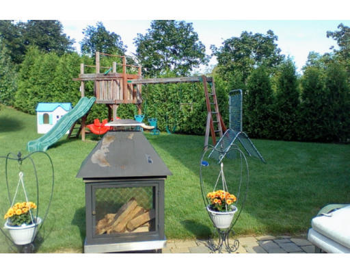 17 Boundary Stone Road Sutton, MA 01590 - Photo 4 of 24 a backyard of a house with barbeque oven table and chairs