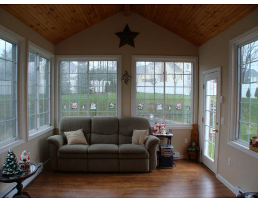 17 Boundary Stone Road Sutton, MA 01590 - Photo 8 of 24 a living room with furniture and a floor to ceiling window