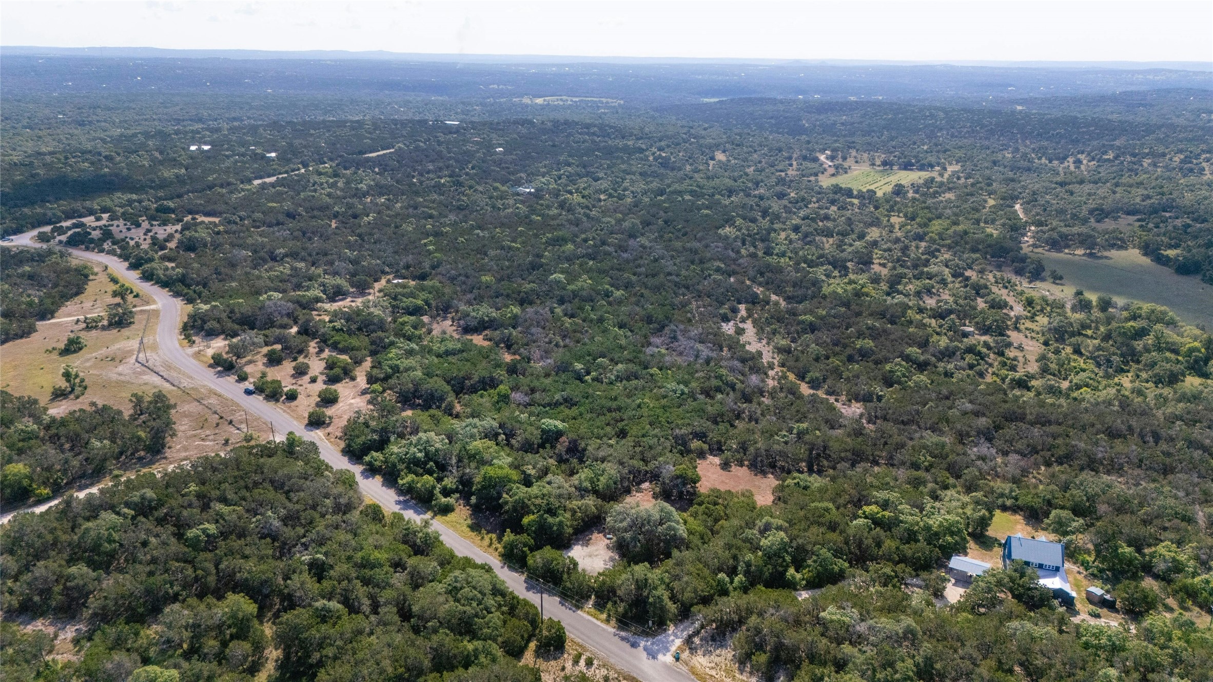 4501 Cottonwood Road Wimberley, TX 78676 - Photo 3 of 7 an aerial view of house with yard and mountain view in back
