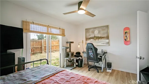a bedroom with furniture and a flat screen tv