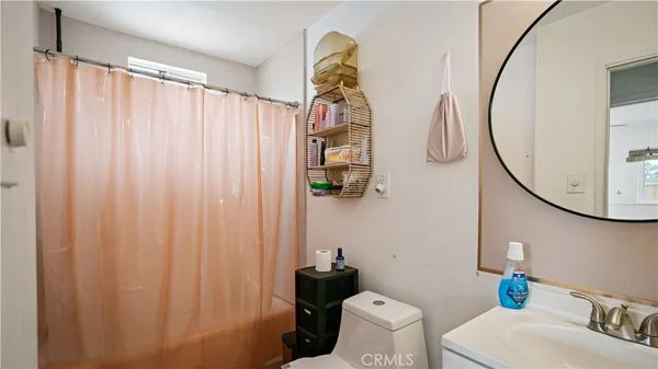 a bathroom with a sink toilet and mirror