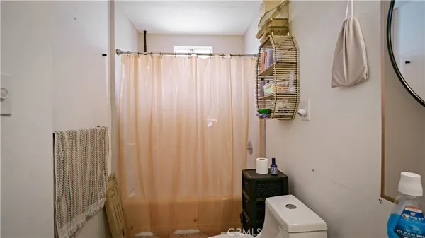 a bathroom with a shower curtain and a window
