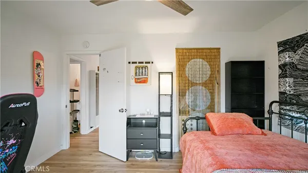 a bedroom with a bed dresser and a large mirror