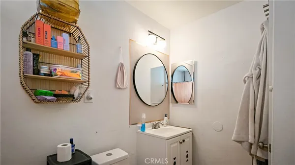 a bathroom with a toilet sink and mirror