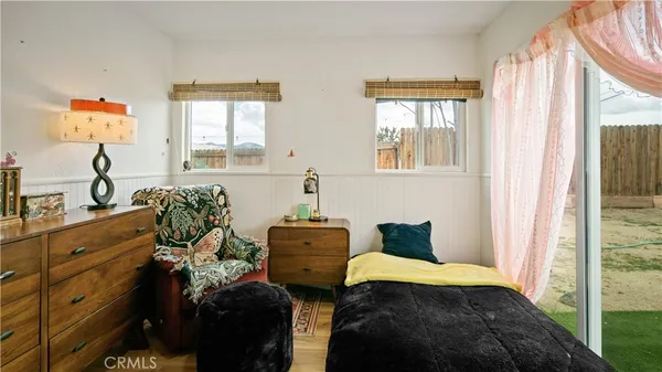a bedroom with a bed and windows