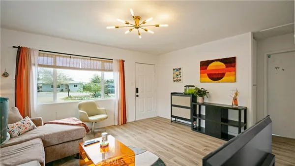 a living room with furniture a rug and a window