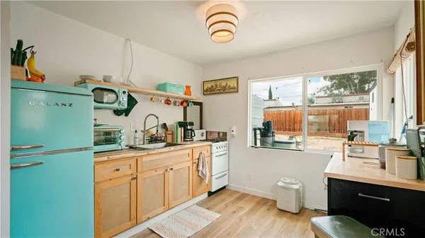 a view of a kitchen with sink dishwasher and wooden floor