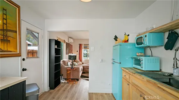 a kitchen with stainless steel appliances granite countertop a refrigerator and a wooden cabinets