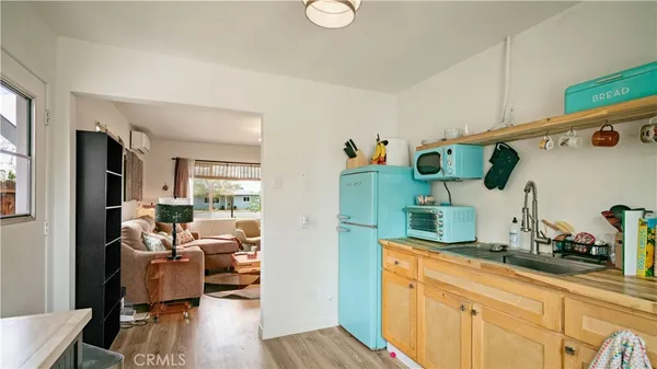 a kitchen with cabinets and wooden floor