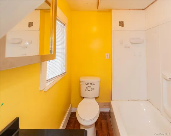 a bathroom with a toilet and a tub