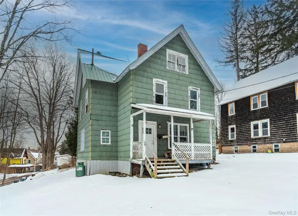 a front view of a house with glass windows and couch