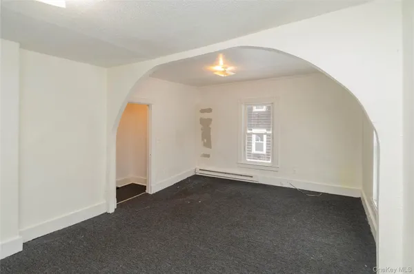 an empty room with a empty space and windows