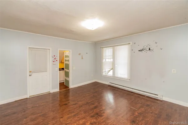 an empty room with windows and closet