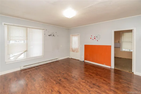 an empty room with windows and closet