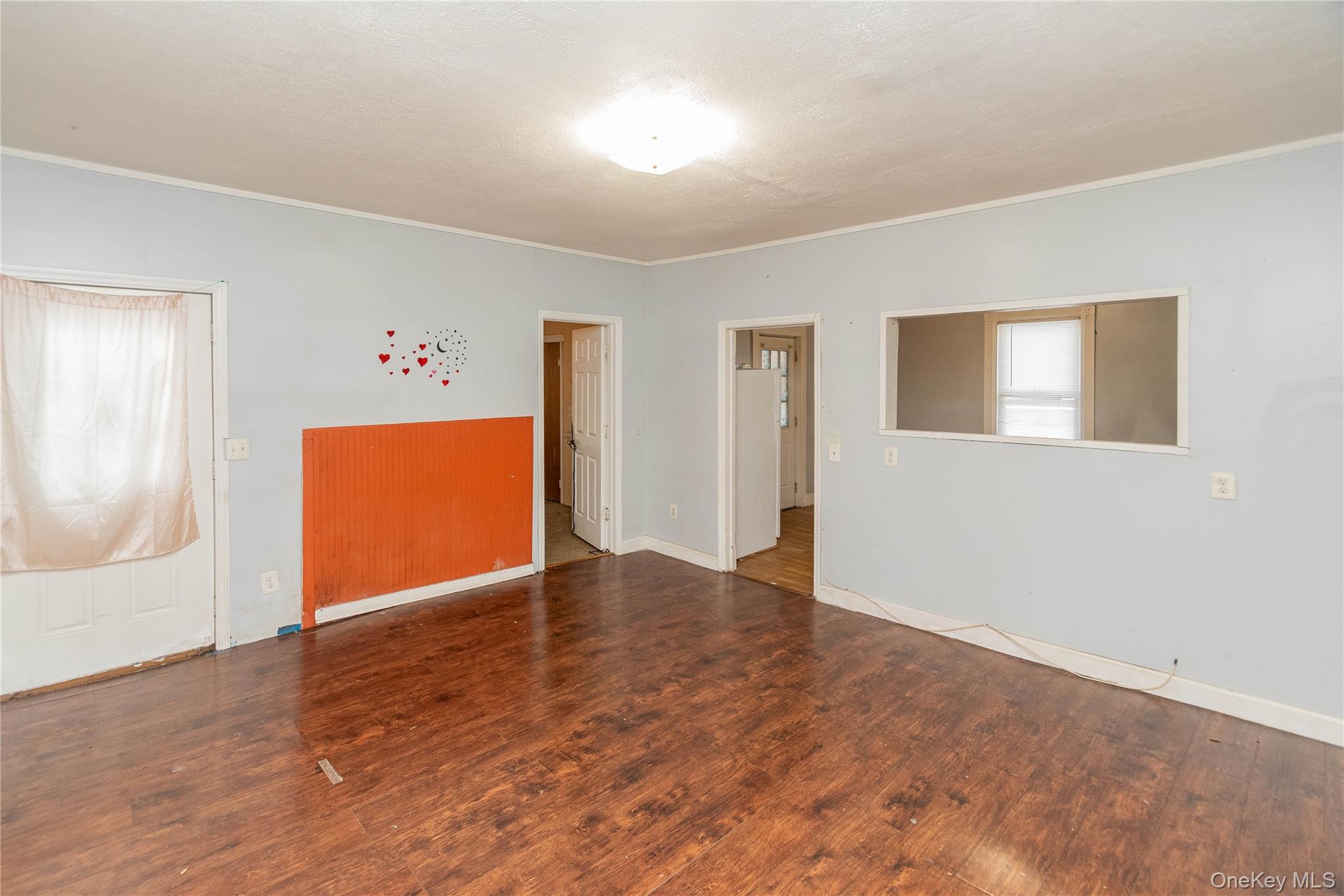 41 Edgar Street Liberty, NY 12754 - Photo 9 of 42 Empty room with wood finished floors, crown molding, and healthy amount of natural light