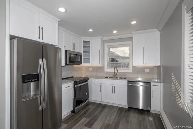 a kitchen with stainless steel appliances a refrigerator sink and microwave