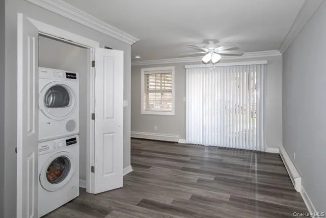 a view of a hallway with wooden floor and a window