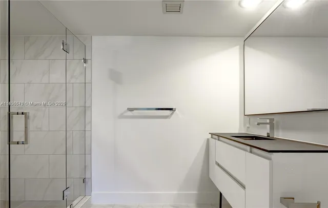 a view of an empty room with a window and bathroom