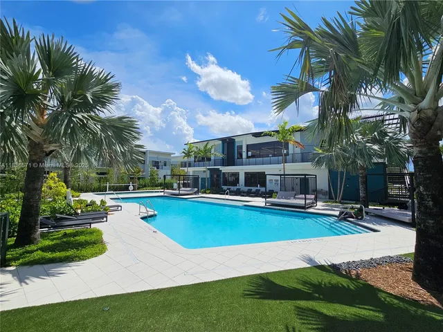 a swimming pool with outdoor seating and yard