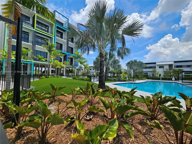 a view of a house with a swimming pool and a big yard