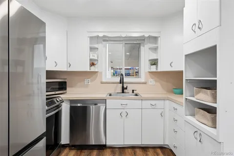 a kitchen with stainless steel appliances granite countertop a refrigerator and a sink