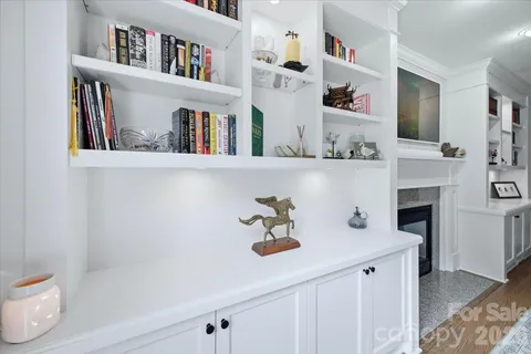 a shelf with books and knick knacks on it