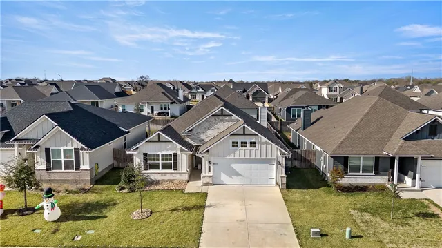 an aerial view of a house with swimming pool and furniture