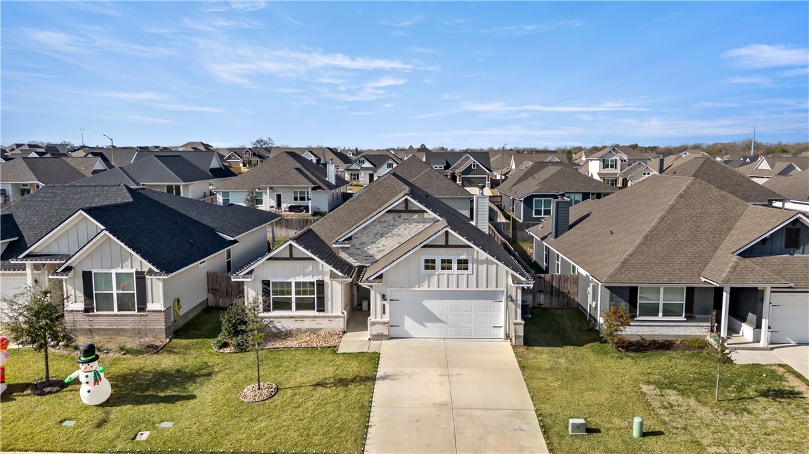 an aerial view of a house with swimming pool and furniture