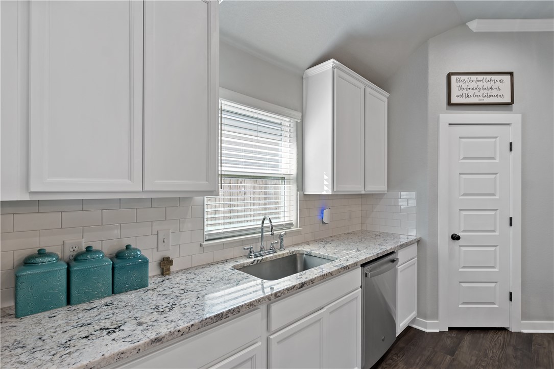 3161 Normandy Way Bryan, TX 77808 - Photo 14 of 27 a kitchen with granite countertop a sink stainless steel appliances and cabinets
