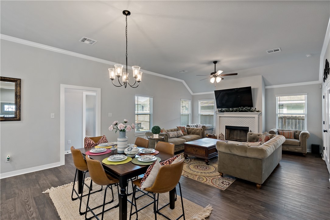 3161 Normandy Way Bryan, TX 77808 - Photo 4 of 27 a living room with furniture a chandelier and a fireplace