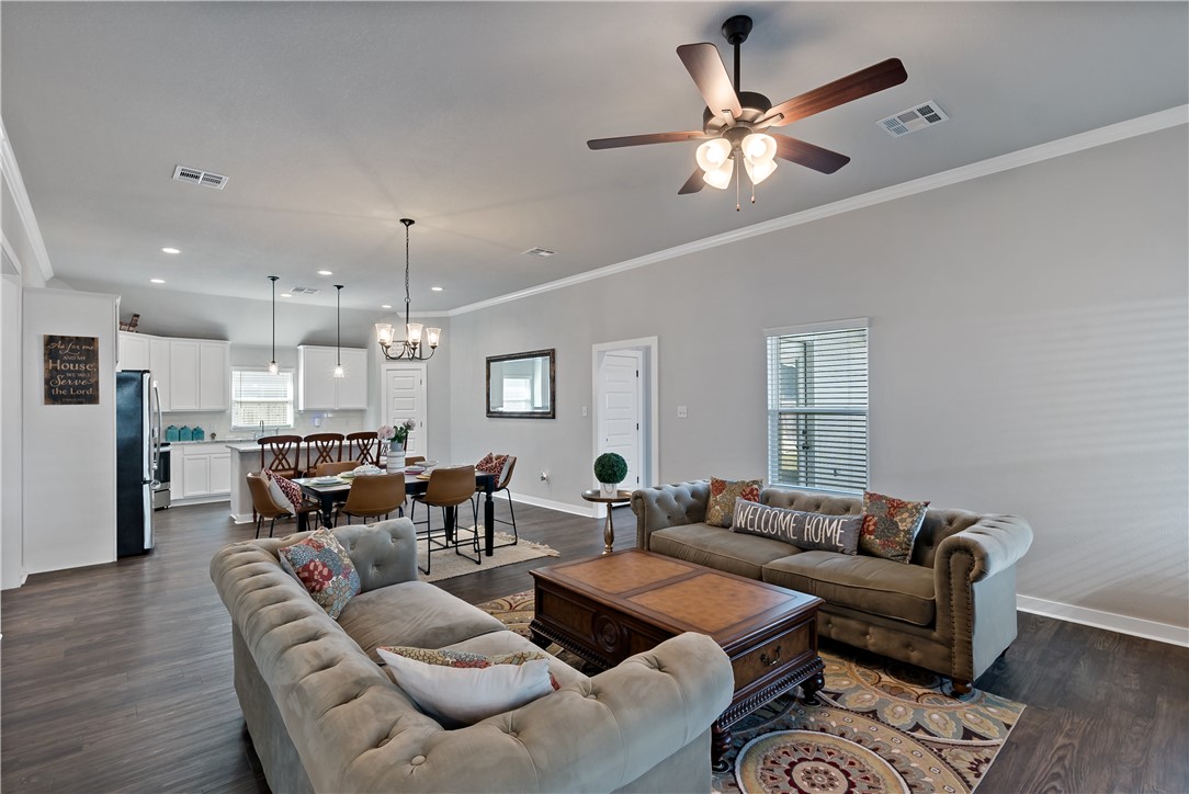 3161 Normandy Way Bryan, TX 77808 - Photo 5 of 27 a living room with furniture kitchen view and a chandelier