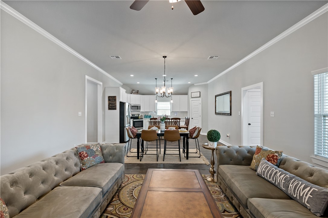 3161 Normandy Way Bryan, TX 77808 - Photo 6 of 27 a living room with furniture and a chandelier