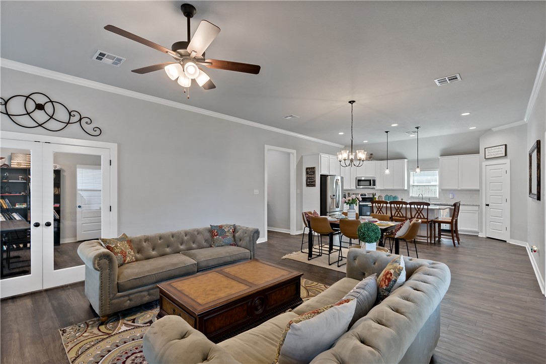 3161 Normandy Way Bryan, TX 77808 - Photo 7 of 27 a living room with furniture kitchen view and a chandelier
