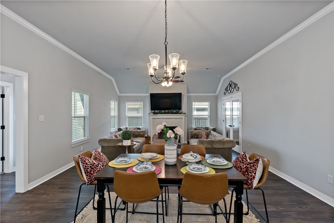 3161 Normandy Way Bryan, TX 77808 - Photo 8 of 27 a view of a dining room with furniture a chandelier and wooden floor