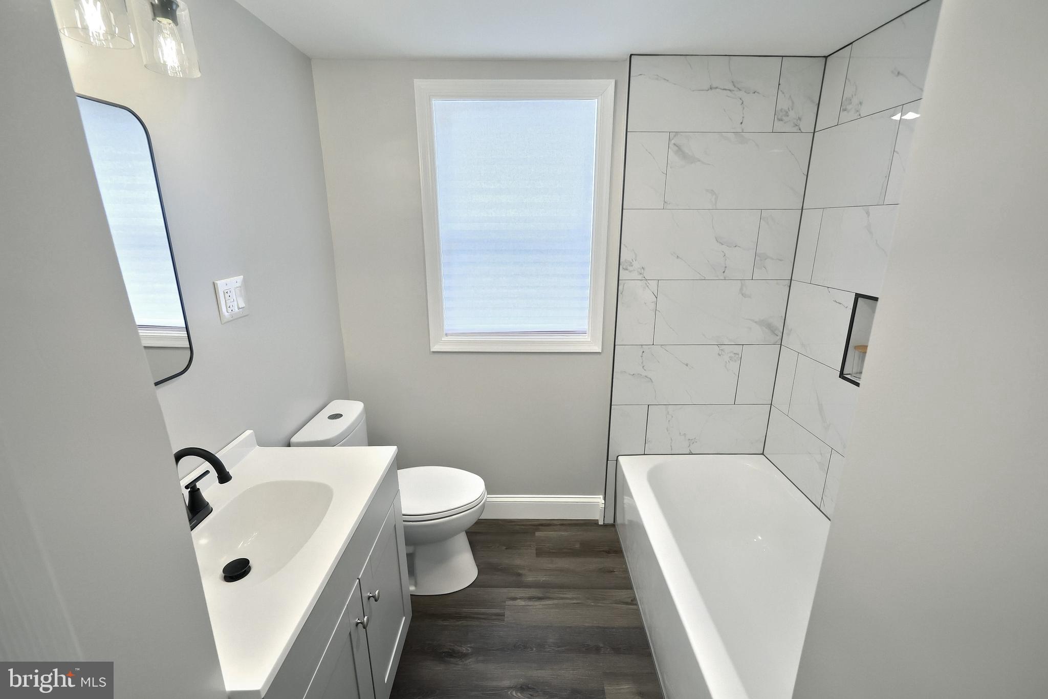 6414 Liberty Road Baltimore, MD 21207 - Photo 14 of 54 a bathroom with a sink a toilet and shower