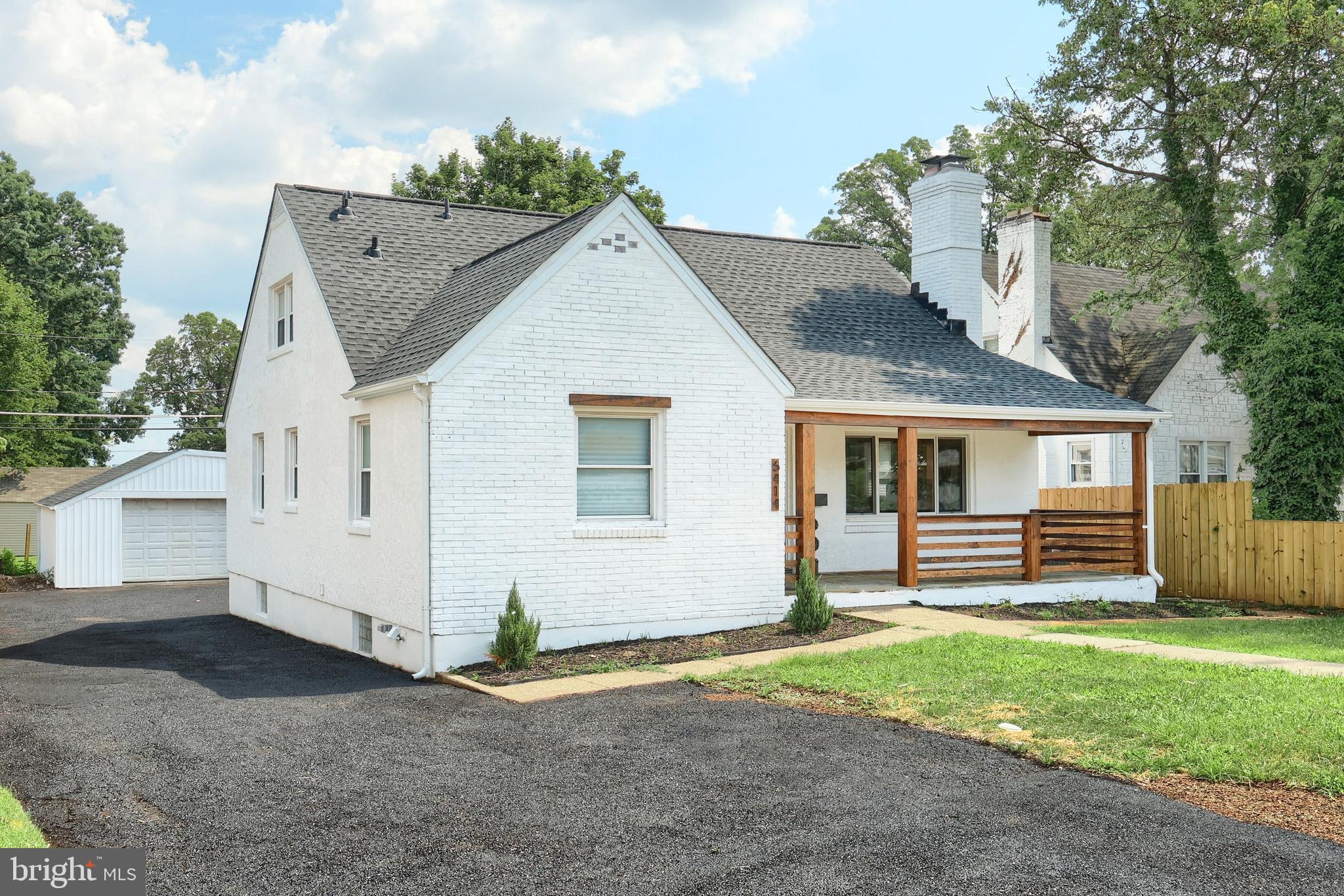 6414 Liberty Road Baltimore, MD 21207 - Photo 2 of 54 a view of a house with a yard and wooden fence