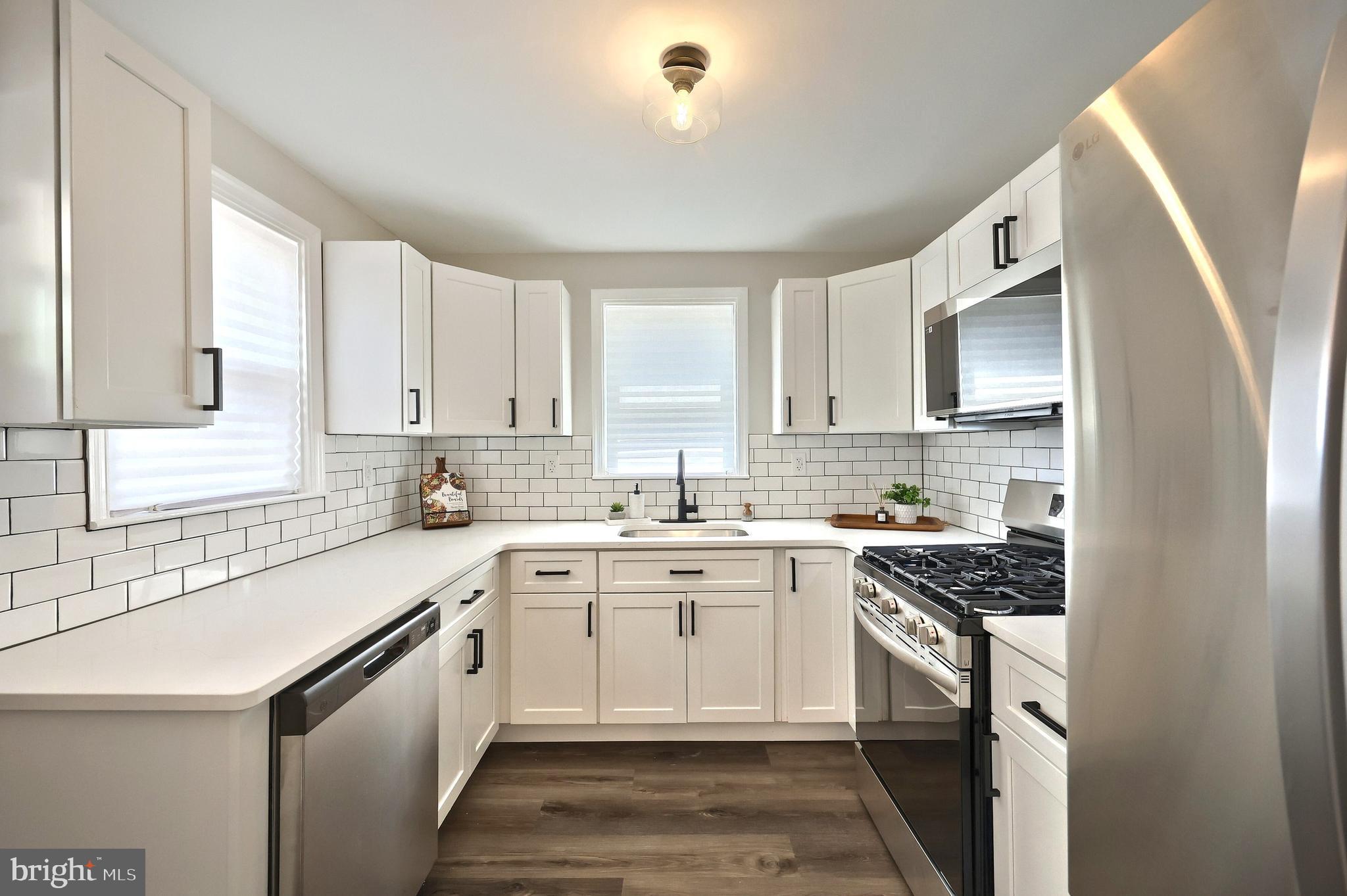 6414 Liberty Road Baltimore, MD 21207 - Photo 25 of 54 a kitchen with a sink stove top oven and refrigerator