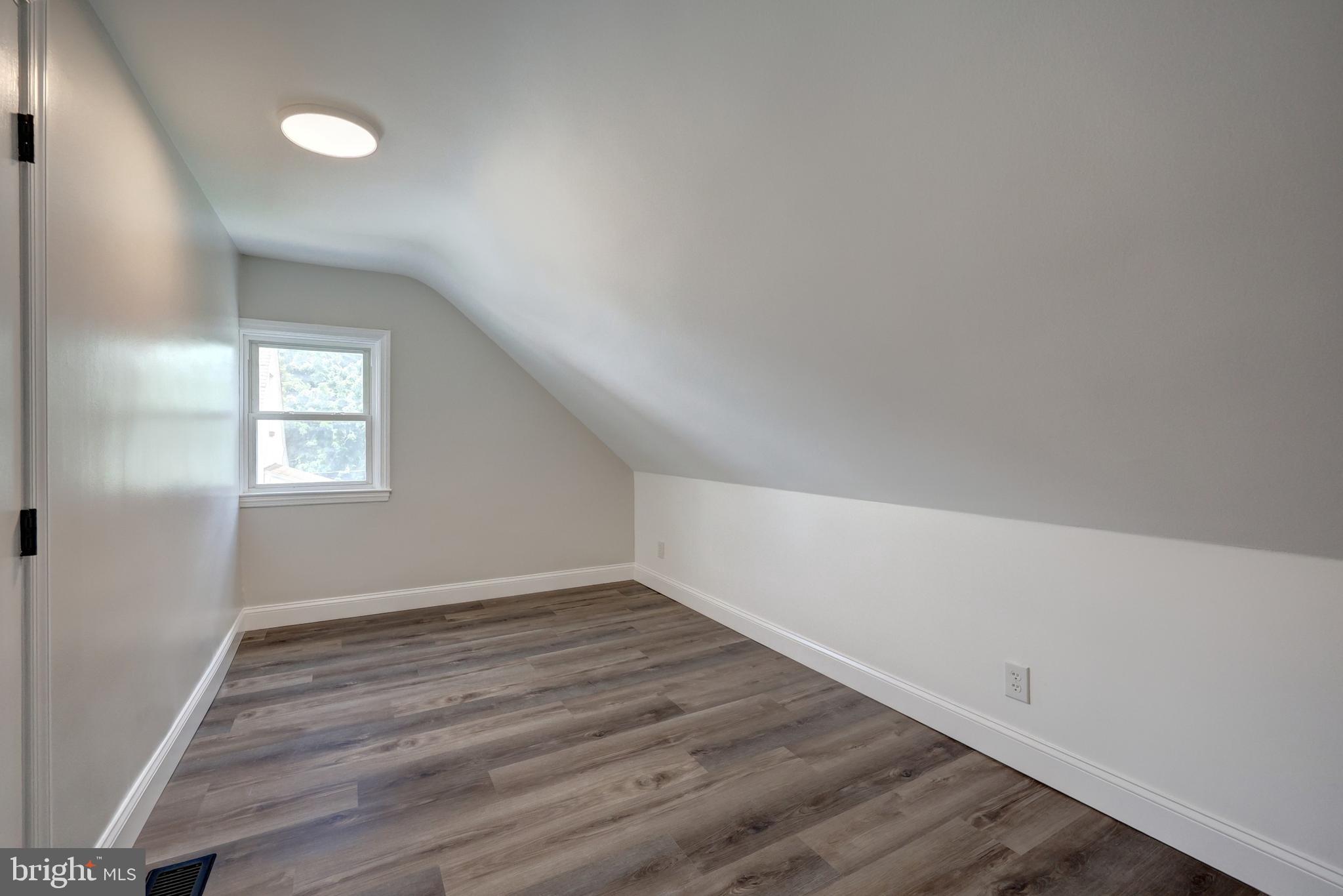 6414 Liberty Road Baltimore, MD 21207 - Photo 32 of 54 wooden floor in an empty room with a window
