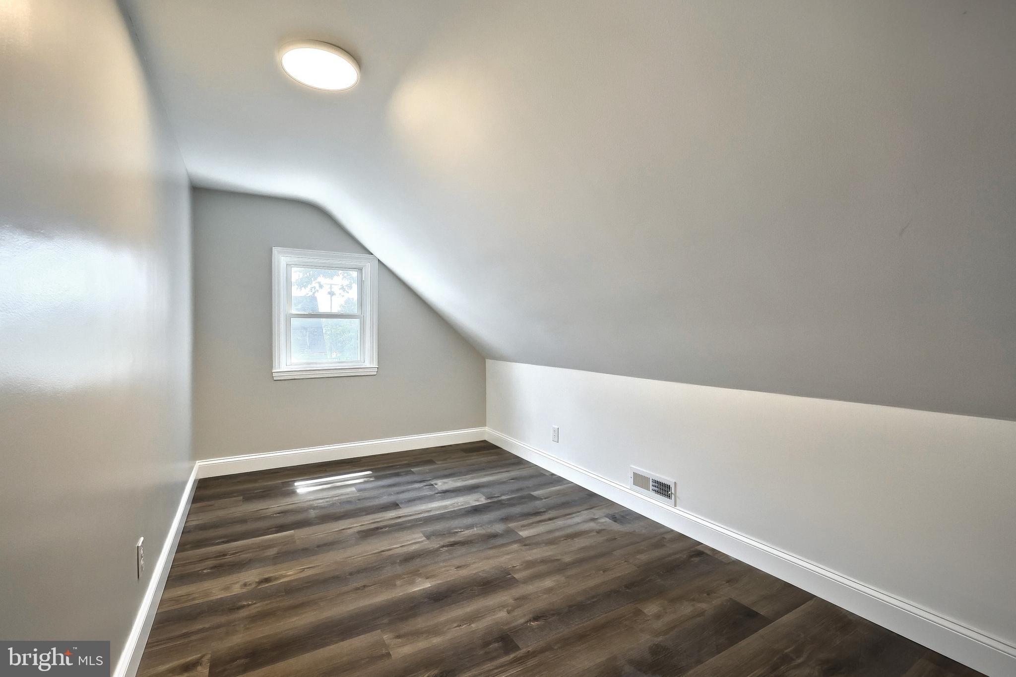 6414 Liberty Road Baltimore, MD 21207 - Photo 35 of 54 an empty room with wooden floor and windows